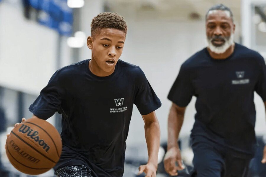 A coach mentoring a student-athlete